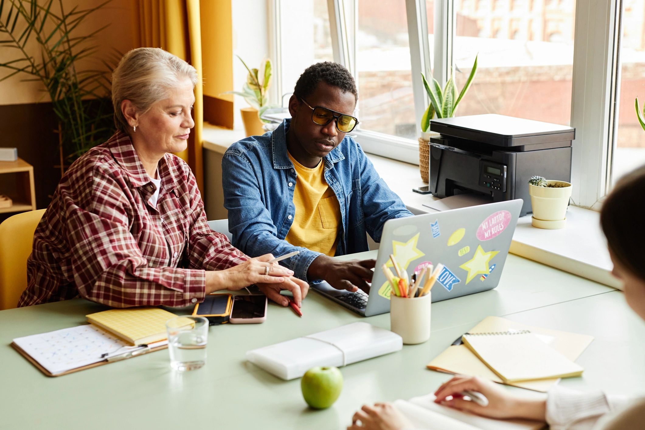 Team reviewing website work on a laptop